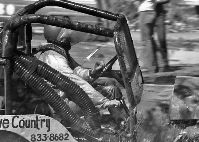 Racer driving modified racing willys jeep through the mud in Yakima